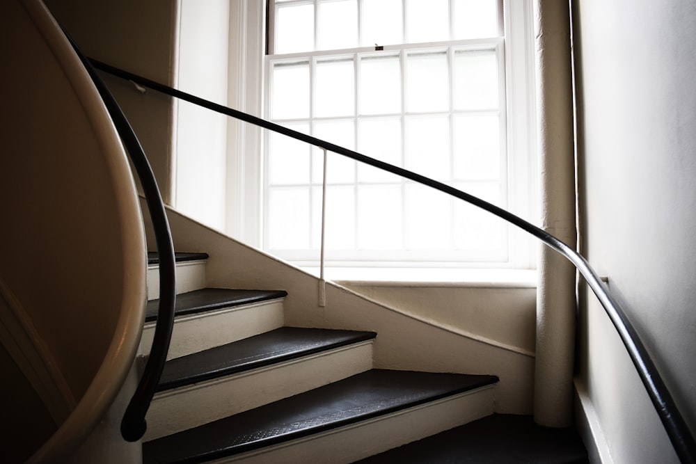 white staircase with black metal railings