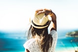 woman holding on to her hat