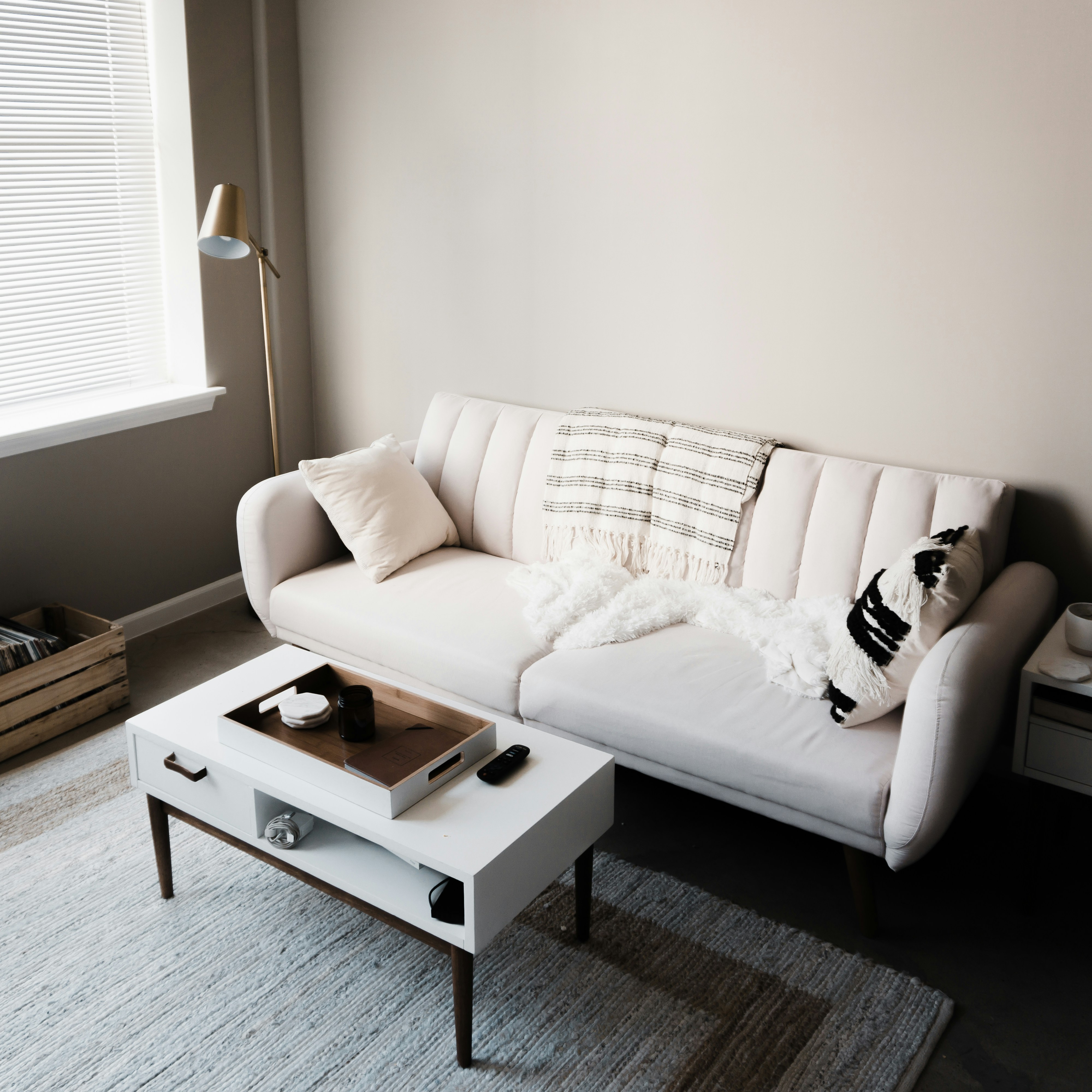 white couch in front of white wooden table