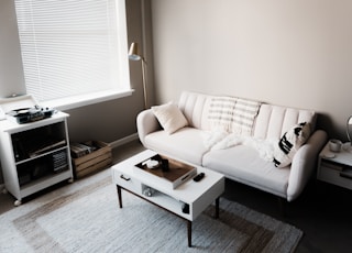 white couch in front of white wooden table