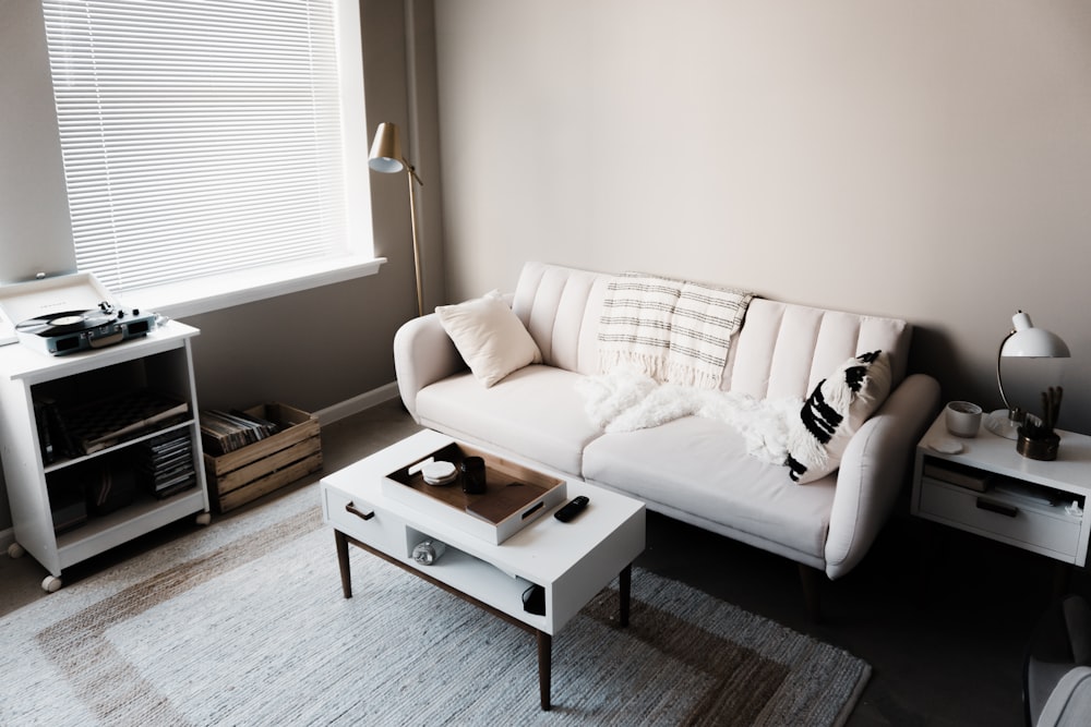 white couch in front of white wooden table