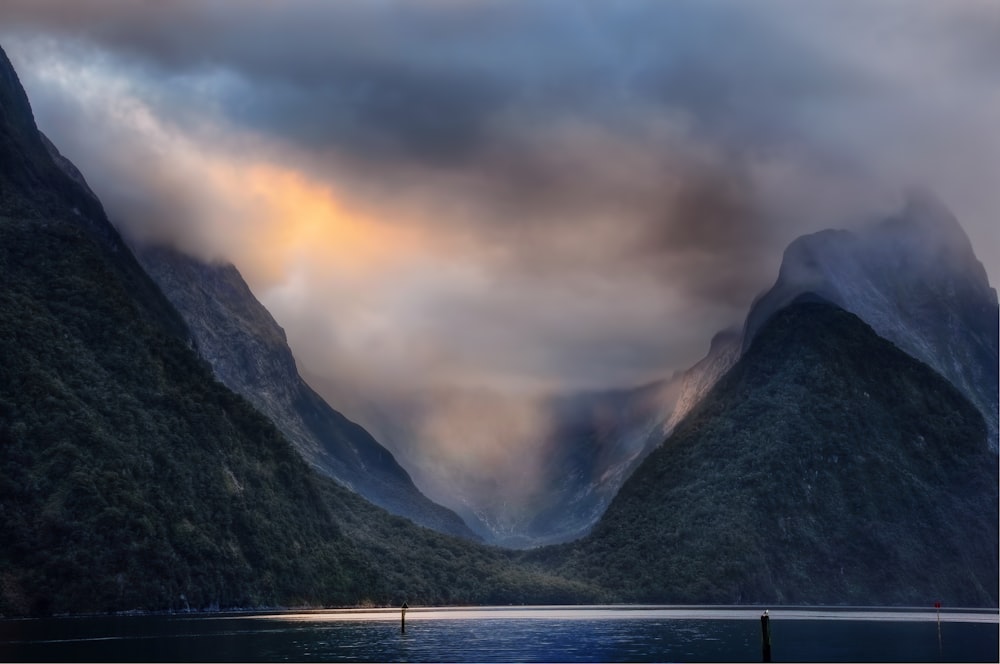 body of water near mountains during daytime photography