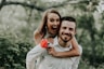 woman riding on back of man