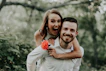 woman riding on back of man