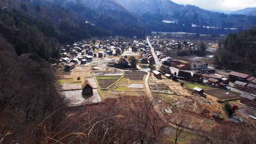 Volunteers distributing food and essentials to elderly villagers in a quiet mountain village.