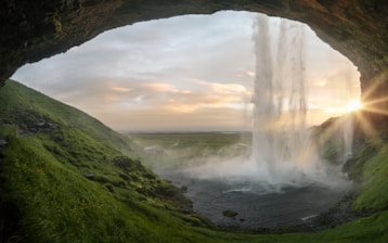 waterfalls near cave at daytime Iceland Sweden Finland Norway travel in nature Natural source