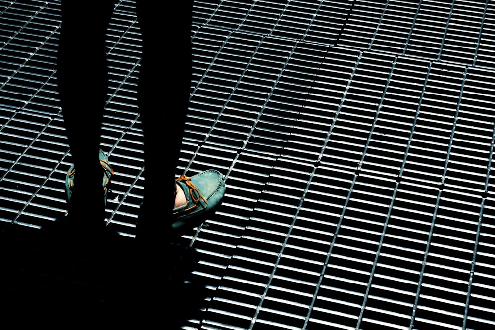 person standing on gray steel grills