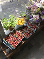 A cozy corner featuring baskets filled with fresh fruits and flowers.
