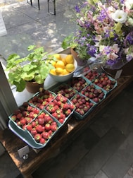 Juicy lemons, ripe strawberries, and fresh blackberries in a colorful basket.