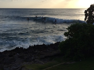 A stunning sunset view of surfers riding waves.
