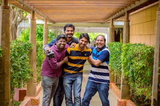 Four friends laughing together in a cozy treehouse, surrounded by books and sunlight.