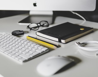 Apple Magic Keyboard and Apple Magic Mouse on white table