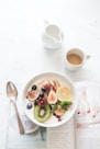 white ceramic plate beside gray steel spoon