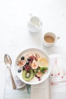white ceramic plate beside gray steel spoon