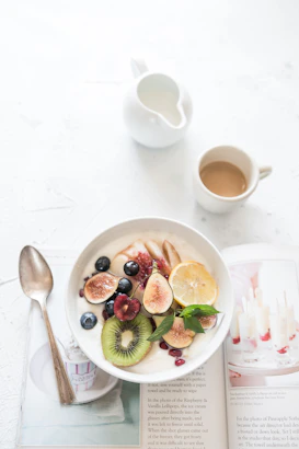 fruit yogurt bowl beside coffee cup