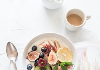 white ceramic plate beside gray steel spoon