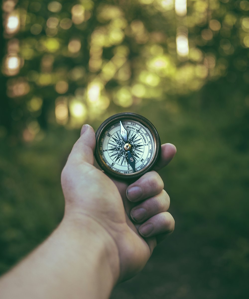 person holding compass