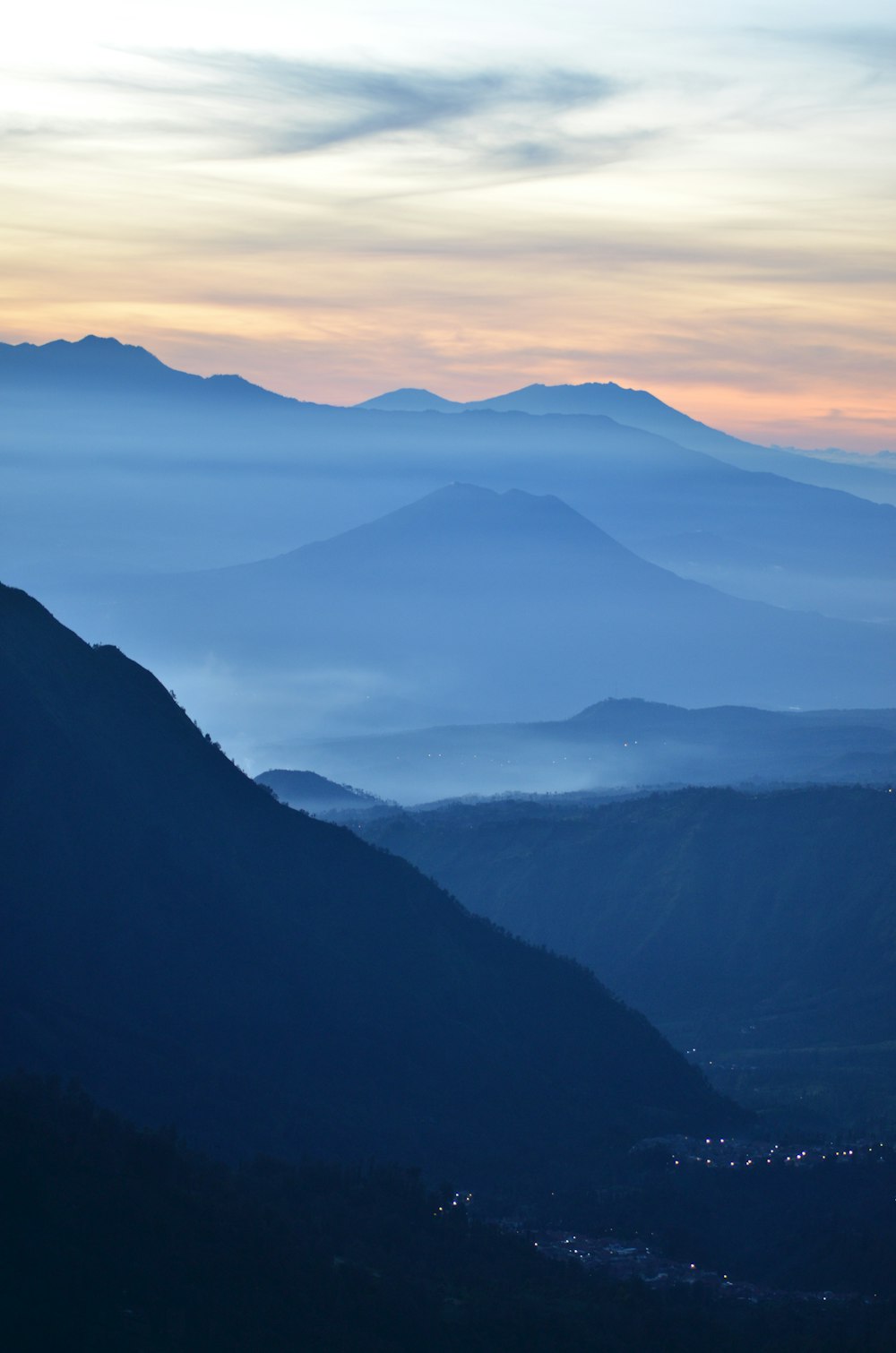 high angle photography of lighted city near mountain