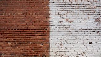 Image showing before and after of a renovated brick wall in a residential building.