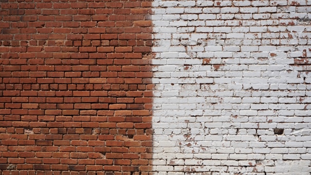 Image showing before and after of a renovated brick wall in a residential building.