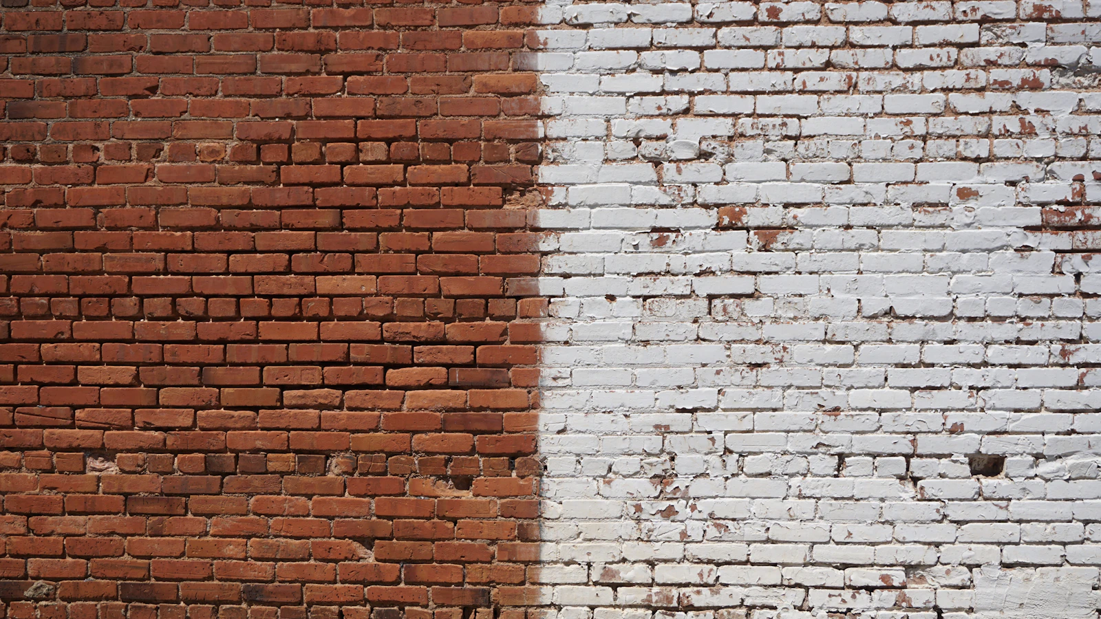 A brick wall with a visibly patched section of newer, different-colored bricks