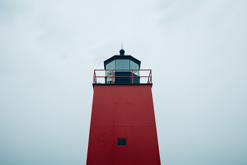 low-angle photograph of red lighthouse