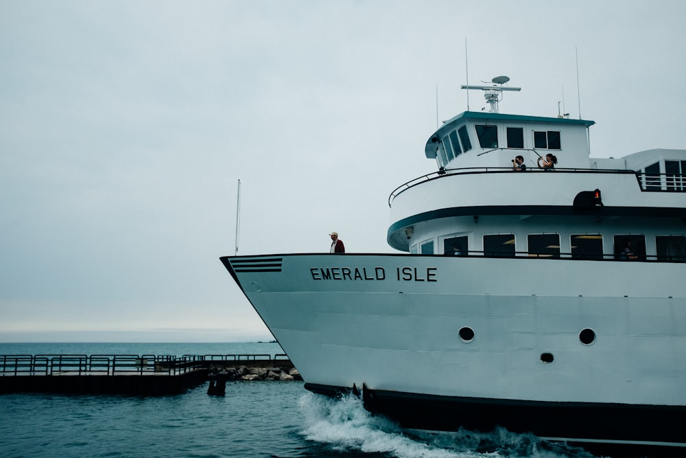 white Emerald Isle boat near dock at daytime