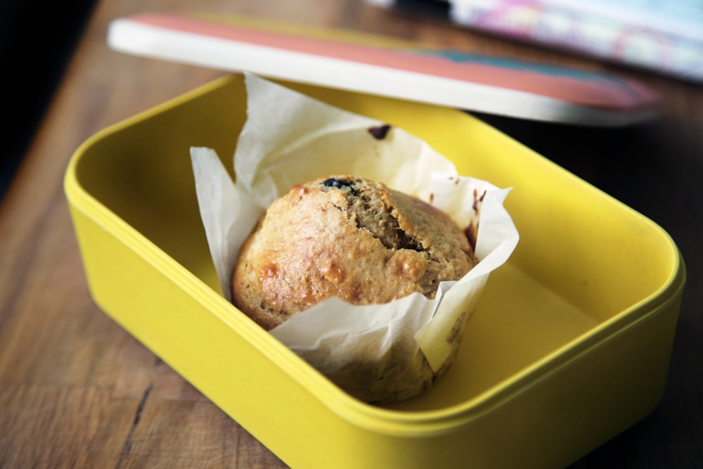 muffin on yellow plastic container