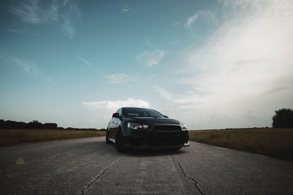 black vehicle on gray concrete road