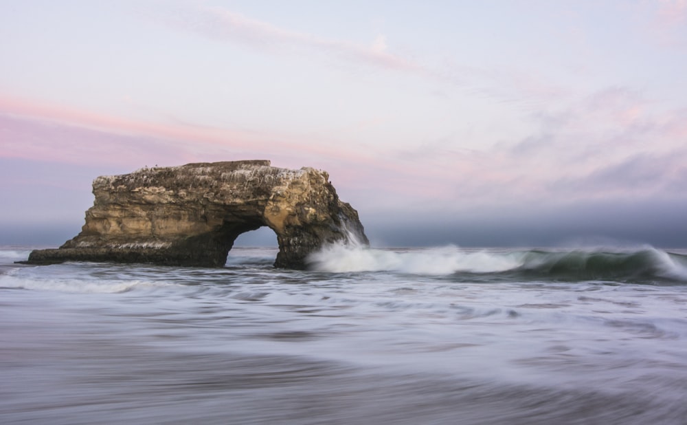 brown rock formation on sea