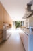 white wooden kitchen island and cupboard cabinets near glass panel door
