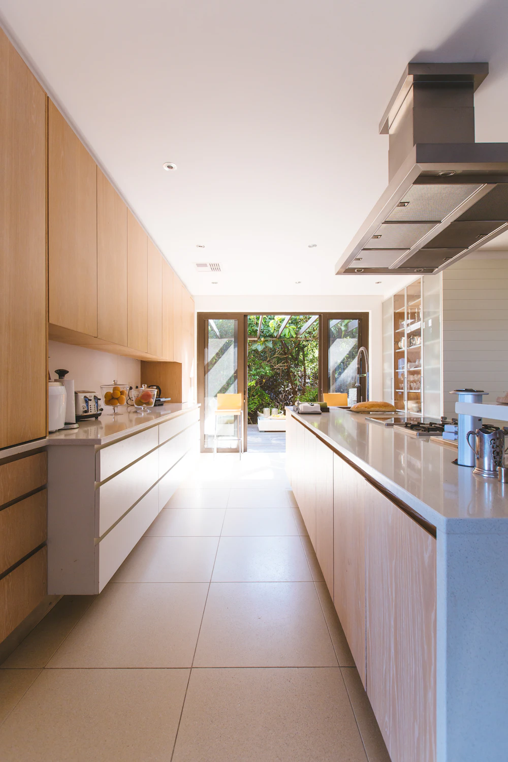 After: open-plan kitchen-diner with bi-fold doors to the garden