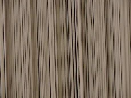 A pattern of vertical lines with varying thickness and shades, creating a barcode-like appearance.