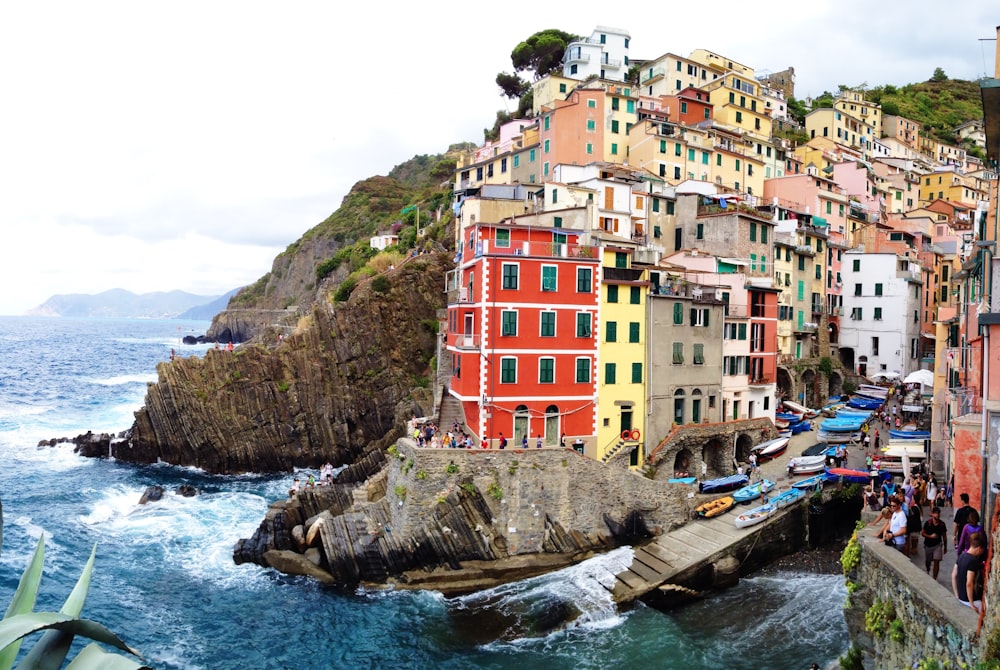 assorted-colored concrete building surrounded by body of water