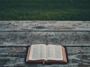 black book on gray wooden table