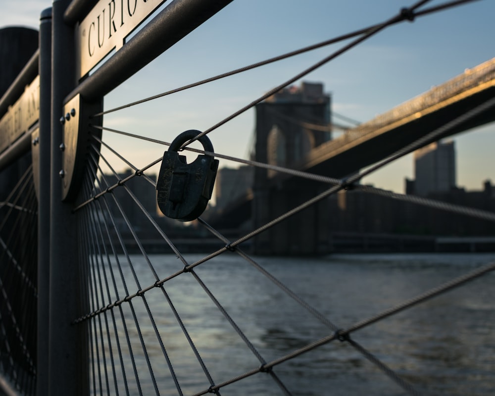 gray padlock on fence