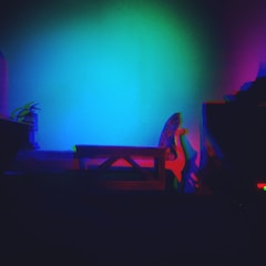 Colorful light therapy setup with vibrant hues illuminating a peaceful space.