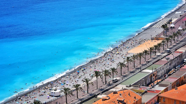 Golden sandy beach with turquoise waters and sunbathers enjoying a warm Málaga afternoon.
