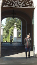 Uniformed security guards monitoring the entrance of a government building.