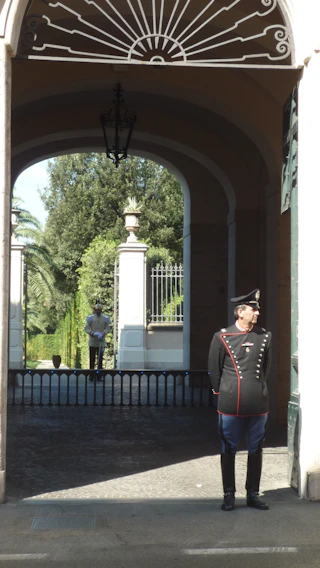 Security guard attentively monitoring entrance at a residential building.