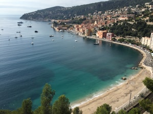 Sunlit private beach with golden sand and turquoise sea, perfect for a yacht stop.