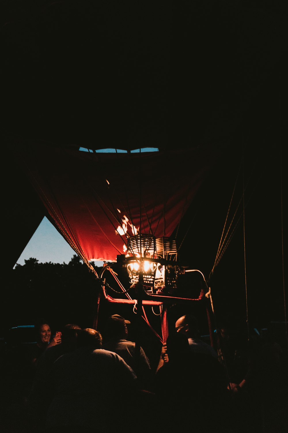 people riding red hot air balloon