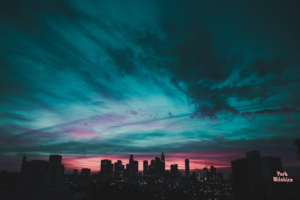 teal sky under city buildings