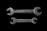 Two metallic open-end wrenches are placed parallel to each other against a black background. The top wrench is slightly larger and has 'MADE IN U.S.A.' engraved on it, while the bottom wrench shows the inscription 'FAIRMOUNT CLEVE'. Both wrenches are weathered, adding a rustic and industrial feel.