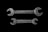 Two metallic open-end wrenches are placed parallel to each other against a black background. The top wrench is slightly larger and has 'MADE IN U.S.A.' engraved on it, while the bottom wrench shows the inscription 'FAIRMOUNT CLEVE'. Both wrenches are weathered, adding a rustic and industrial feel.