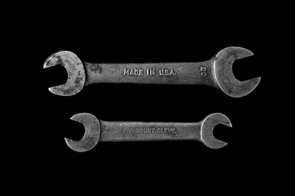 two gray open wrenches