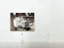 A satisfied customer admiring a large abstract painting in their home.