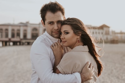 man hugging woman during daytime