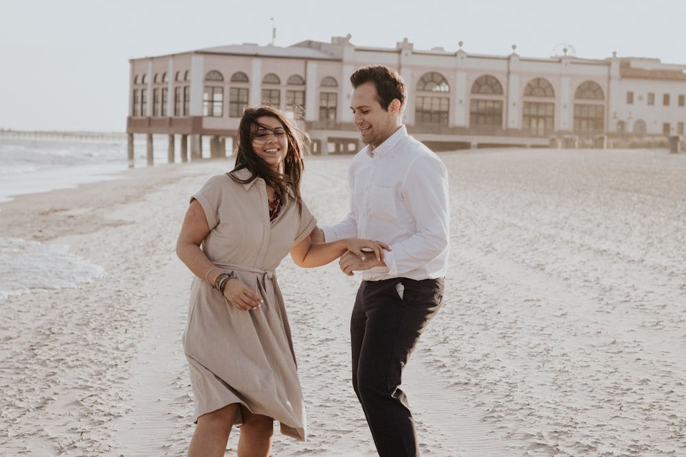 man holding woman's hand and shoulder