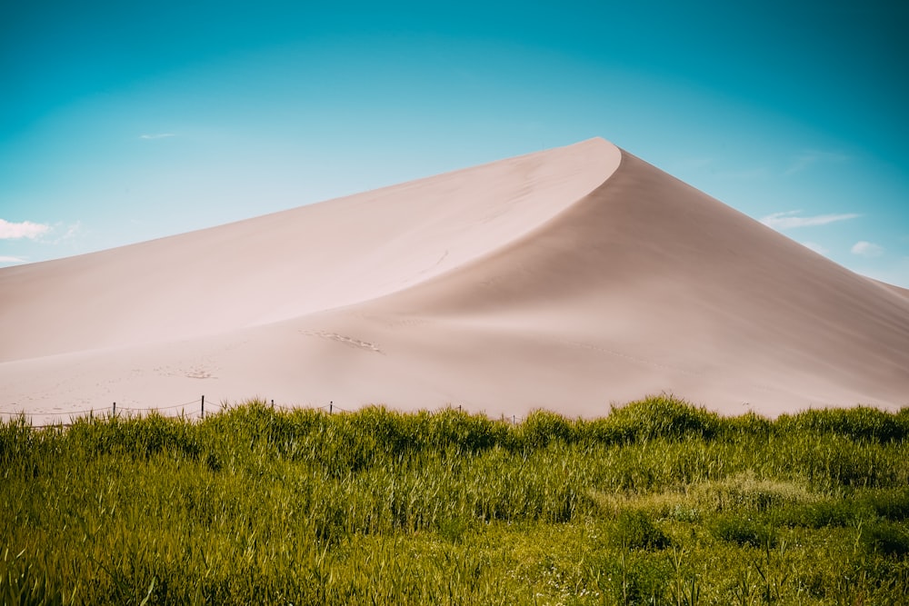 desert mountain near green field